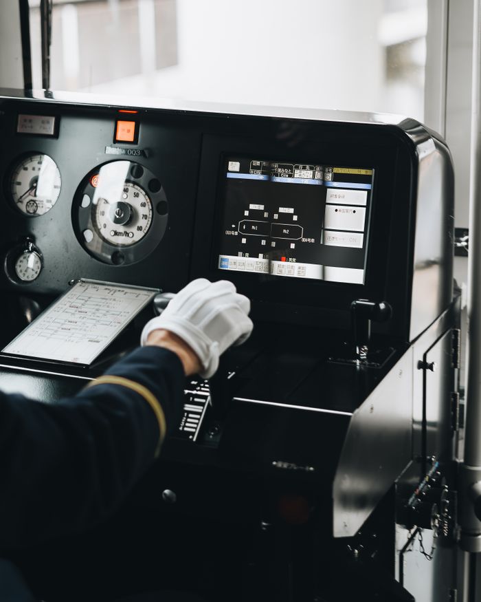Home A train driver operates modern train controls with precision, showcasing interior technology.